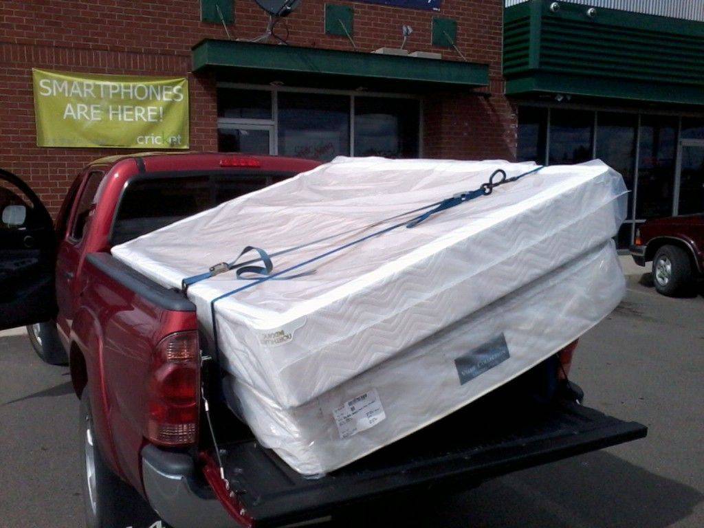 king size mattress in a pickup truck